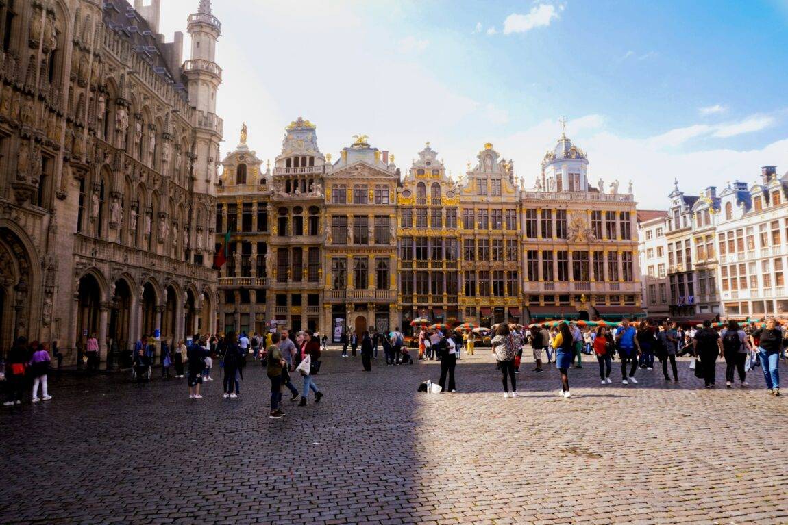 The Grand Place in brussels filled with people in front of ornate buildings