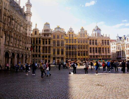 The Grand Place in brussels filled with people in front of ornate buildings